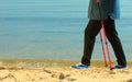 Active woman senior nordic walking on a beach. legs Royalty Free Stock Photo