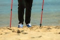 Active woman senior nordic walking on a beach. legs Royalty Free Stock Photo