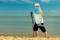 Active woman senior nordic walking on a beach Royalty Free Stock Photo