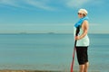 Active woman senior nordic walking on a beach Royalty Free Stock Photo