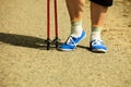 Active woman senior nordic walking in park. legs