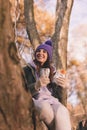 Woman having breakfast while taking hiking break in forest spending autumn day outdoors Royalty Free Stock Photo