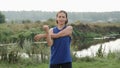 Active woman stretching outdoor after running training. Female in sportswear stretching in park before exercising. Woman stretchin