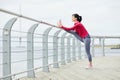 Active Woman Stretching on Pier Royalty Free Stock Photo