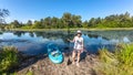 Active woman with SUP board near beautiful lake, nature on background, stand up paddling water adventure outdoors Royalty Free Stock Photo