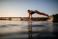 Active woman with surf style wakeboard in her hands flies over the water Royalty Free Stock Photo