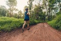 Active woman trail runner running in the forest in the morning Royalty Free Stock Photo