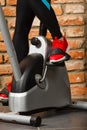 Active woman using exercise bike at the gym. Royalty Free Stock Photo