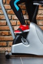 Active woman using exercise bike at the gym. Royalty Free Stock Photo