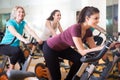 Active women of different age training on exercise bikes Royalty Free Stock Photo