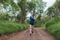 Active young Asian woman running at tropical forest trail Royalty Free Stock Photo