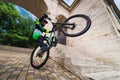 Active young biker jumping on the rear wheel of a mountain bike. Extreme sport. Wide angle front view of a cyclist Royalty Free Stock Photo