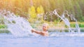 Active young cheerful blonde woman splashing water spray scatter in river. Beautiful healthy lady relax and laughing Royalty Free Stock Photo