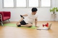 Active young cheerful man doing morning gymnastic at home