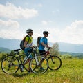 ACTIVE Young couple biking on a forest road in mountain on a spring day Royalty Free Stock Photo