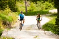 ACTIVE Young couple biking on a forest road in mountain on a spring day Royalty Free Stock Photo
