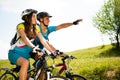 ACTIVE Young couple biking on a forest road in mountain on a spring day Royalty Free Stock Photo