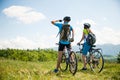 ACTIVE Young couple biking on a forest road in mountain on a spring day Royalty Free Stock Photo