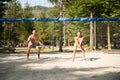 Active young couple play beach volley on hot wimmer day