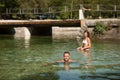 Active young couple plays in shallow water on a hot summer morning