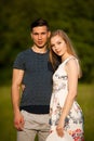 Active young couple on a wlak in the park on hot summer afternoon