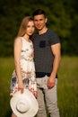 Active young couple on a wlak in the park on hot summer afternoon