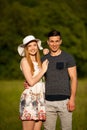 Active young couple on a wlak in the park on hot summer afternoon