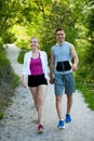 Active young couple on a wlak in the park on hot summer afternoon