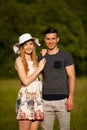 Active young couple on a wlak in the park on hot summer afternoon