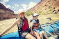 Active young family enjoying a fun whitewater rafting trip