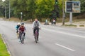 Active young father with son and daughter having bicycle ride on a Dnepr river embankment