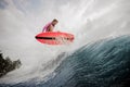 Active young girl jumping on the orange wakeboard Royalty Free Stock Photo