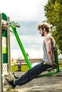 Active man exercising on leg press outdoor. Royalty Free Stock Photo