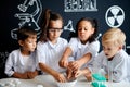 Multiracial diverse kids with test tubes studying chemistry at school laboratory Royalty Free Stock Photo