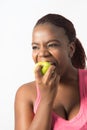 Active Young Woman biting a green apple Royalty Free Stock Photo