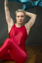 Young woman in red unitard waving a blue scarf. Royalty Free Stock Photo