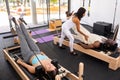 Active young Woman doing pilates exercises lying on pilates workout machines Royalty Free Stock Photo