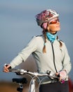 Active young woman with her bicycle