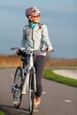 Active young woman with her bicycle