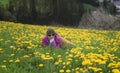 Active young woman laying on the meadow covered with flowers and having rest Royalty Free Stock Photo