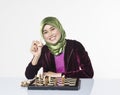 Active young woman playing chess over white background