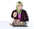 Active young woman playing chess over white background