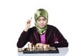 Active young woman playing chess over white background