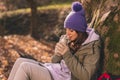 Woman drinking hot tea while taking a hiking break Royalty Free Stock Photo