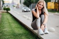 Woman in sport clothes resting on street after cycling Royalty Free Stock Photo