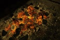 Actively smoldering embers of fire. Background, copy space. Royalty Free Stock Photo