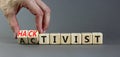 Activist or hacktivist symbol. Businessman turns wooden cubes and changes the word Activist to Hacktivist. Beautiful grey table