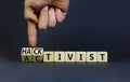 Activist or hacktivist symbol. Businessman turns wooden cubes and changes the word Activist to Hacktivist. Beautiful grey table