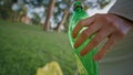 Activist hand holding plastic bottle at cleanup park closeup. Eco volunteer Royalty Free Stock Photo