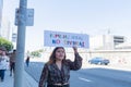An activist holds a sign during The Families Belong Together mar